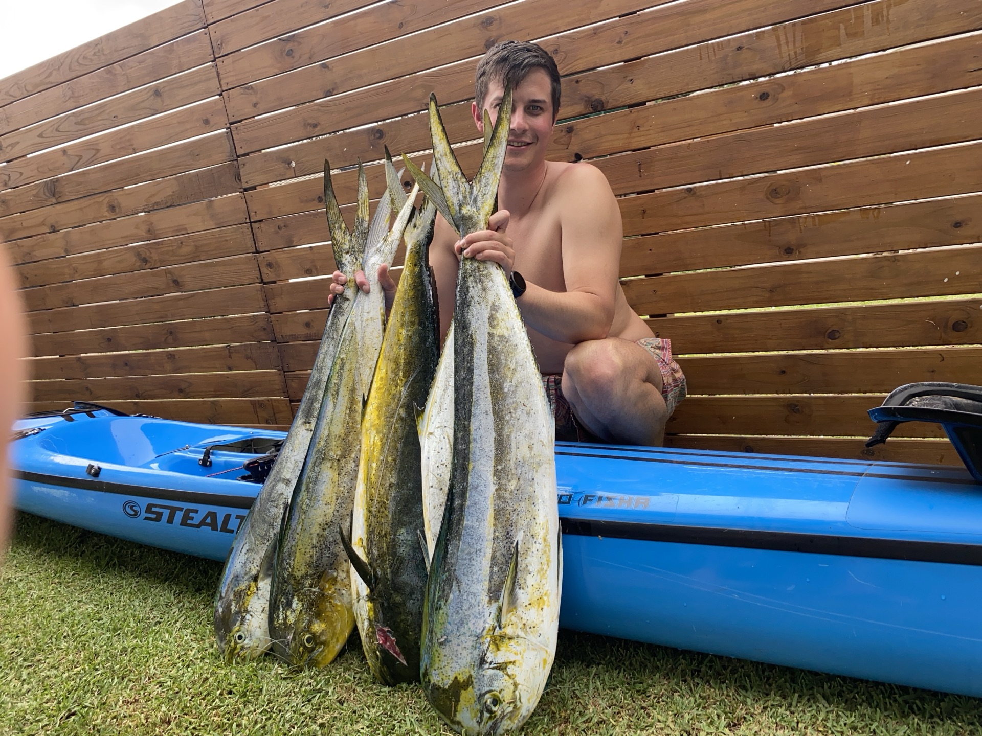 Angler on a kayak holding a big fish